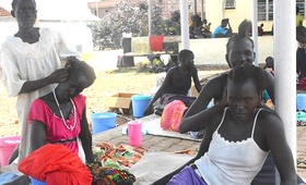 Women from Aweil fix each other's hair as they prepare to go home after their fistula repair surgery.