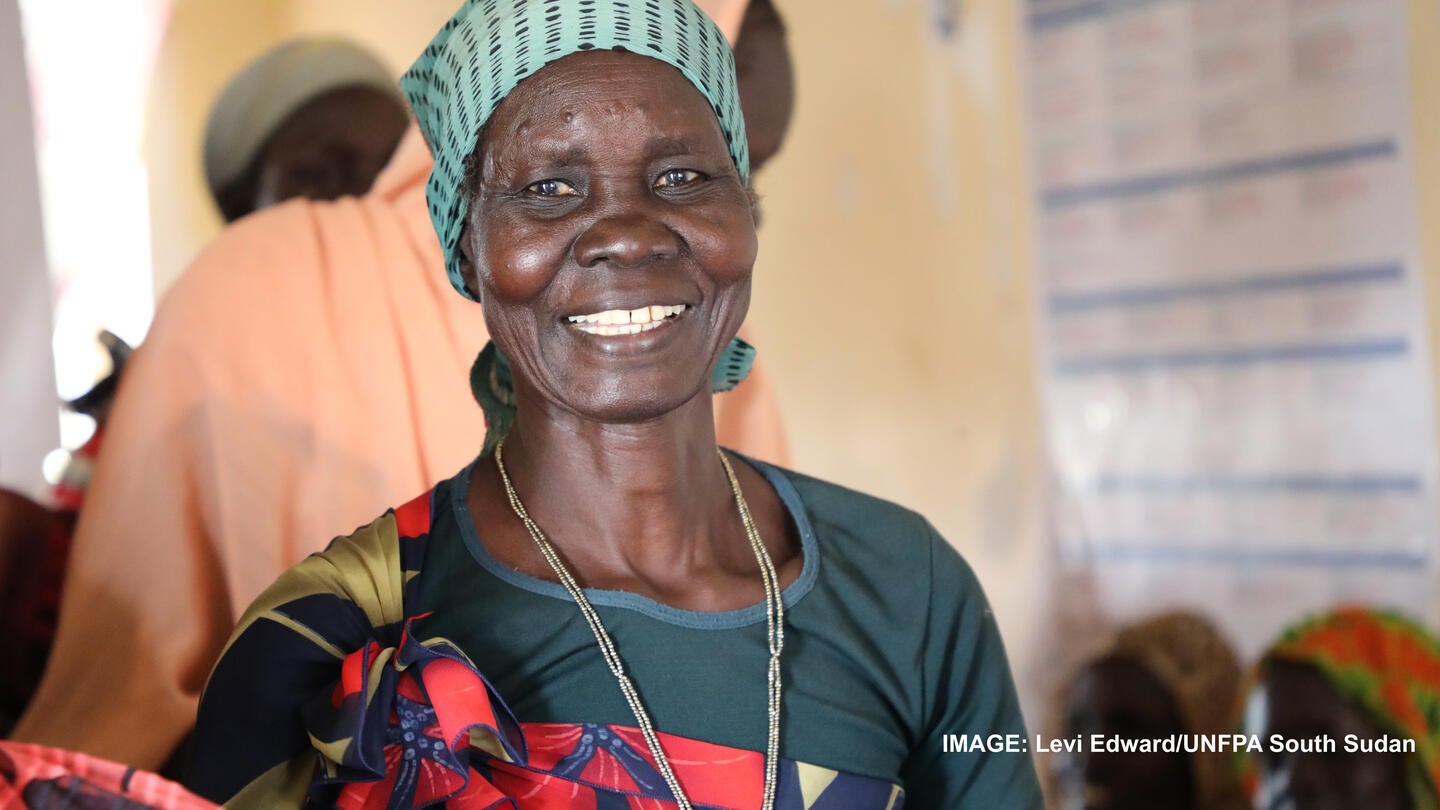 A South Sudanese woman, who recently returned from Sudan, smiling at Renk Women and Girls Friendly Space