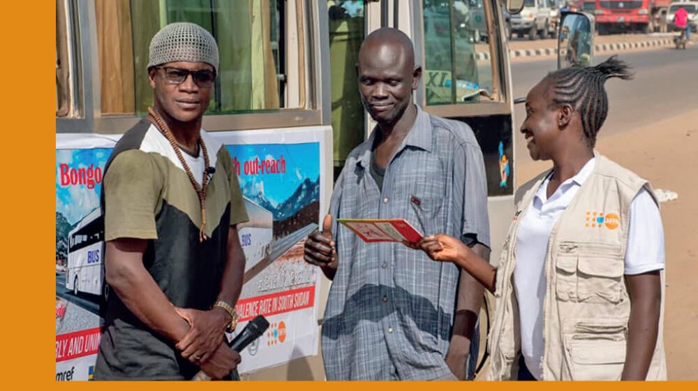 Comedian VIP Reagan & Esther Wayo engaging a male passerby.