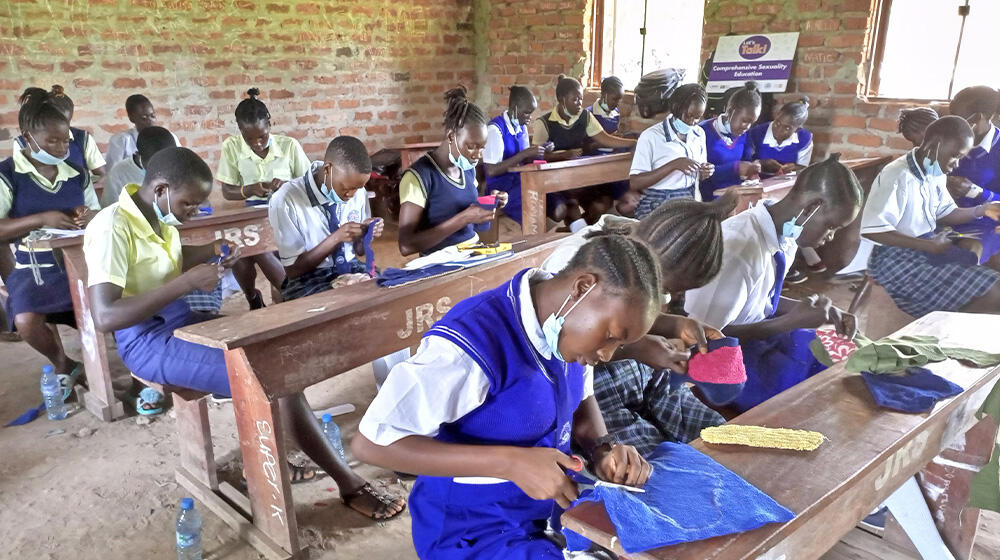 School Girls learning skills on making re-usable sanitary pads 